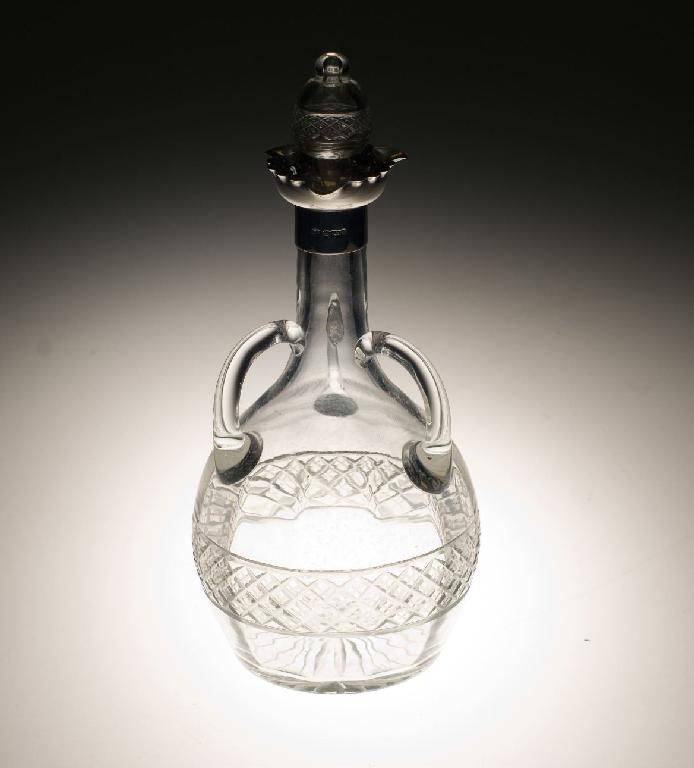 Appraisal: EDWARD VII SILVER-MOUNTED CUT-GLASS THREE-HANDLED DECANTER Sheffield with silver collar