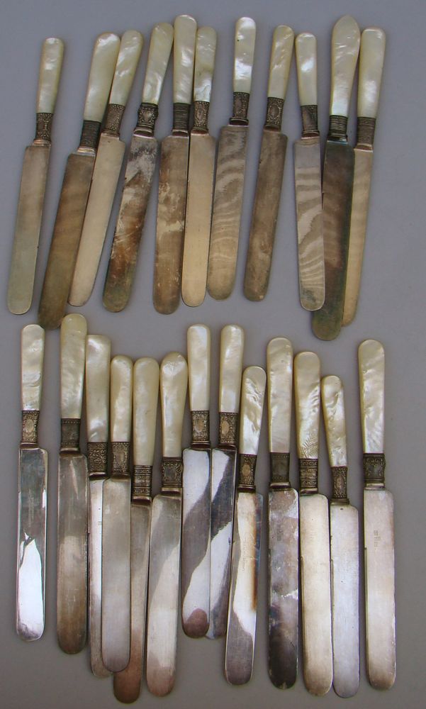 Appraisal: TWENTY-FOUR MOTHER-OF-PEARL HANDLED KNIVES By various makers Sterling silver ferrules