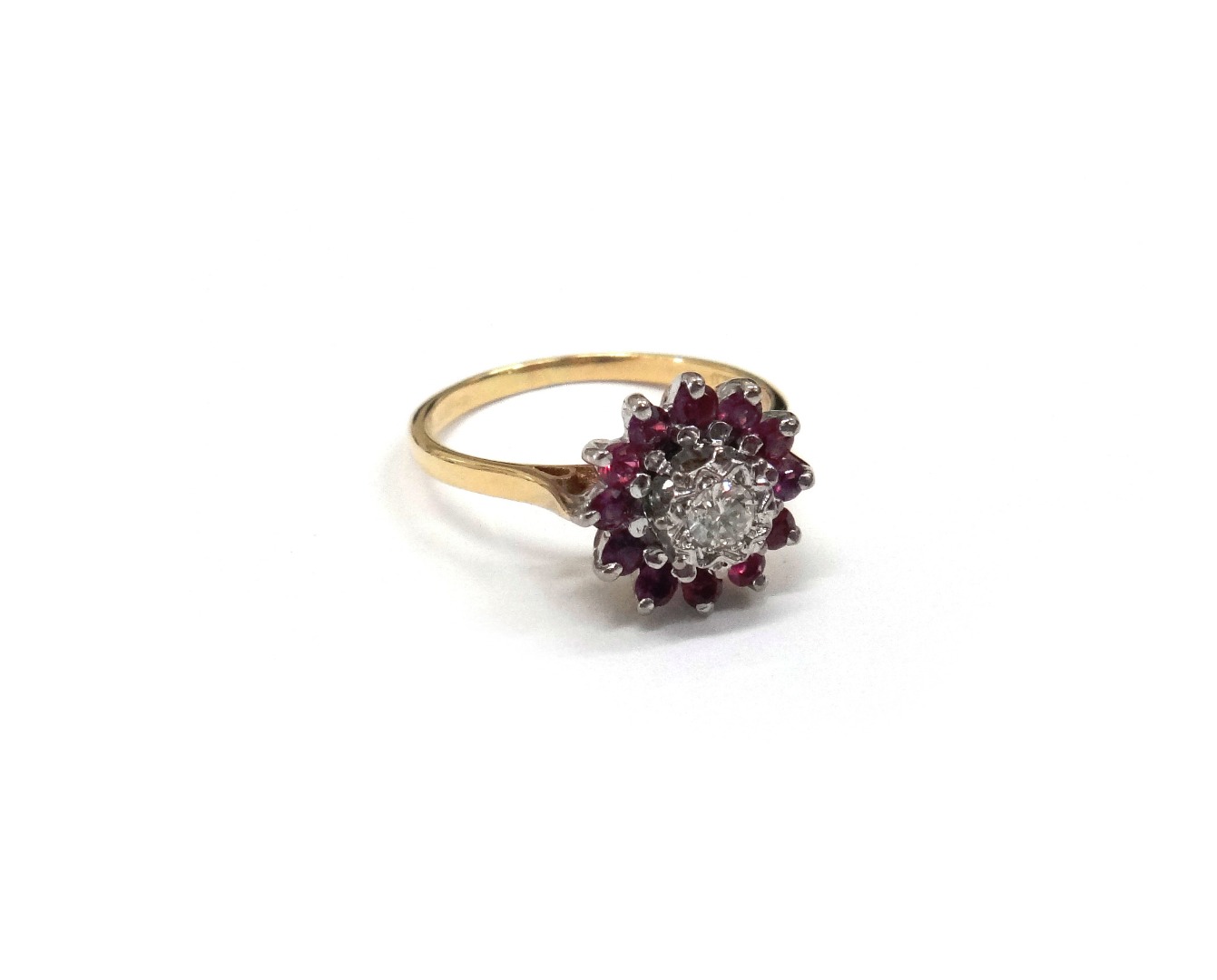 Appraisal: A gold ruby and diamond cluster ring detailed ' ct'