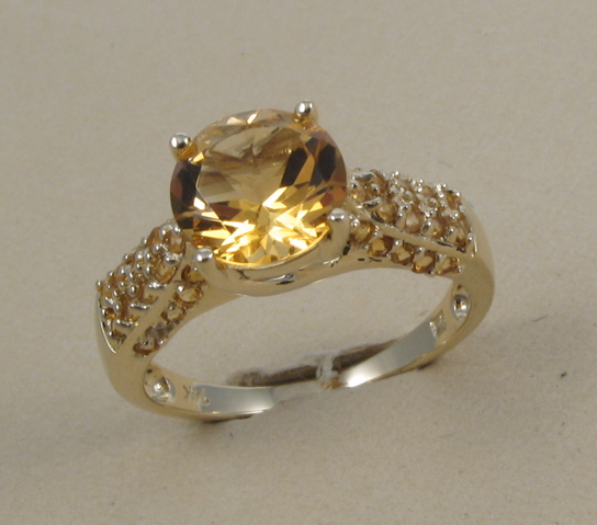 Appraisal: CITRINE AND FOURTEEN KARAT GOLD RING centering a round-cut citrine