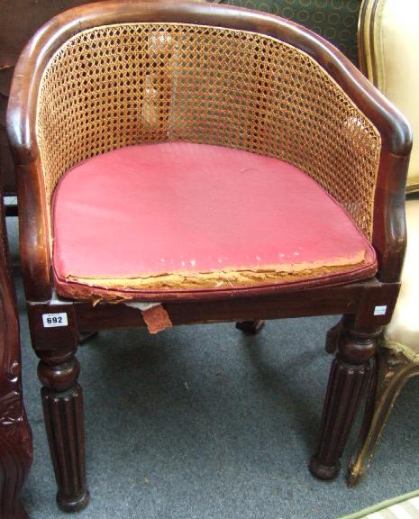 Appraisal: A th century mahogany and cane-work tub chair raised on