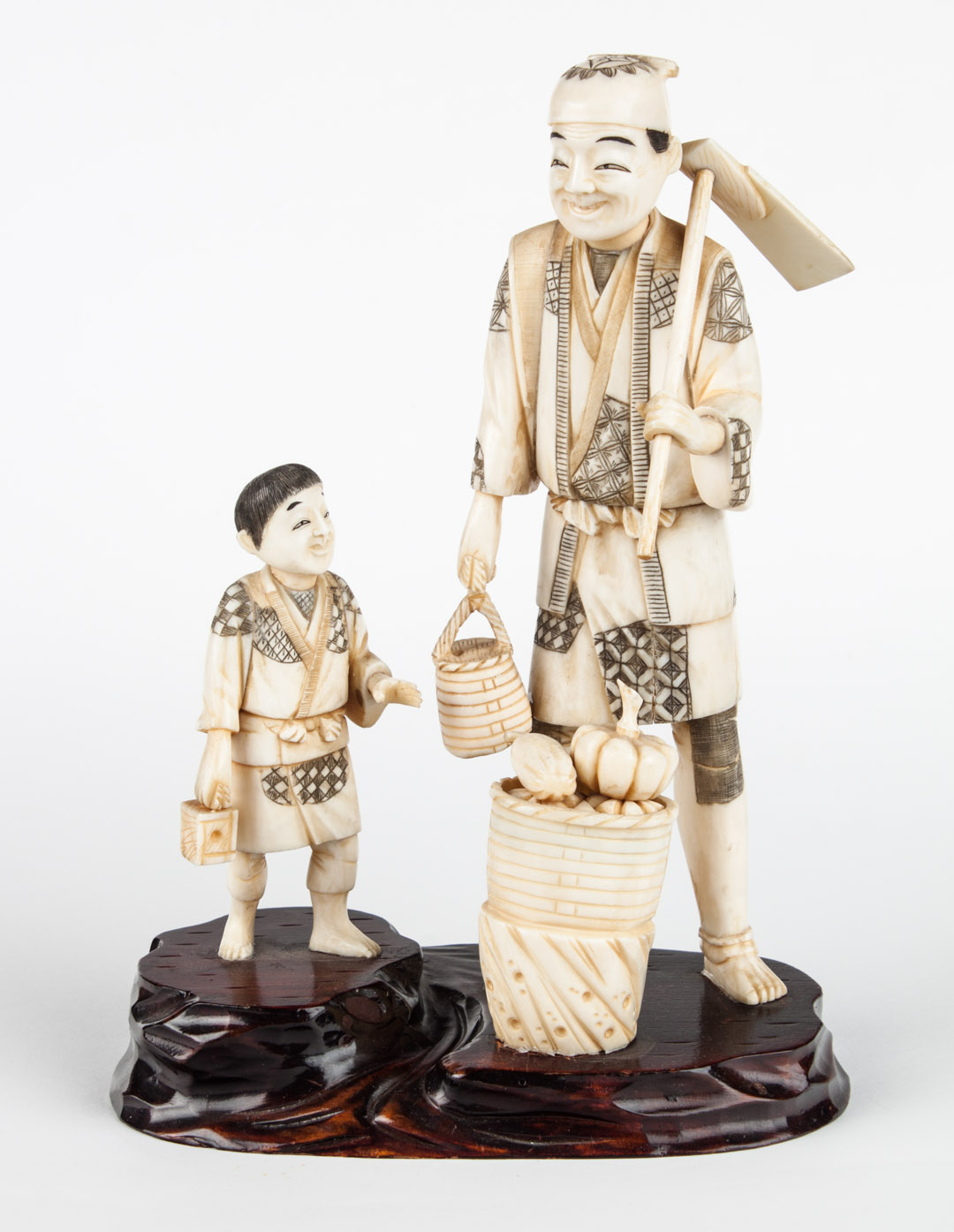 Appraisal: Japanese carved ivory farmer group modeled as farmer with a