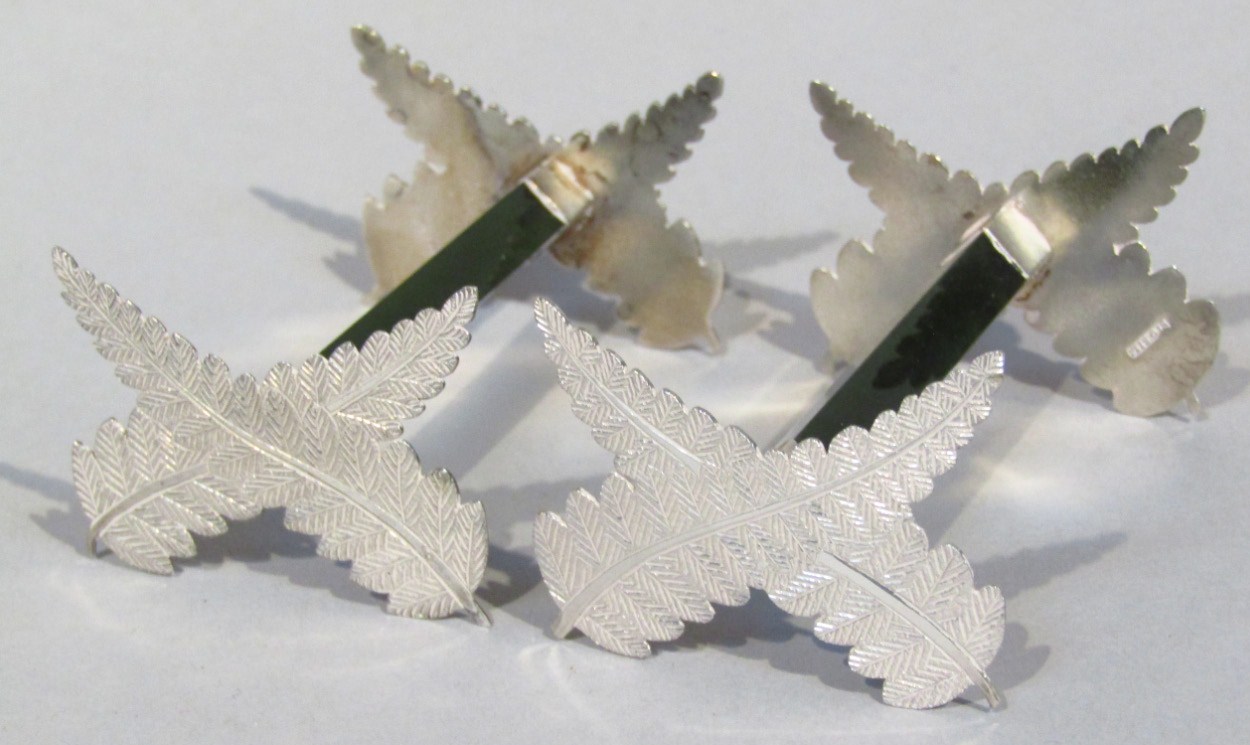 Appraisal: A pair of white metal and jade knife rests each