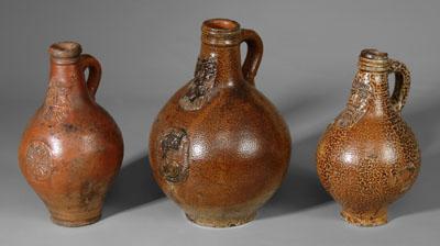 Appraisal: Three German Bellarmine jugs salt glazed stoneware one with bearded