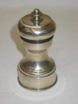 Appraisal: A PEPPER GRINDER of waisted form with moulded base high