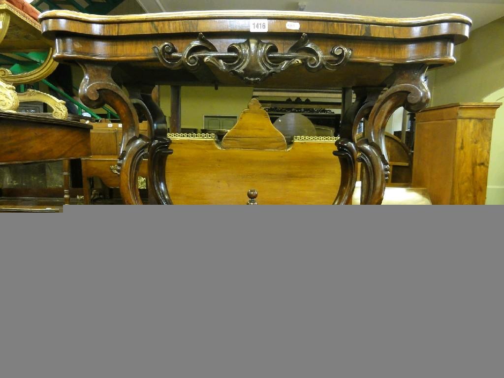 Appraisal: A Victorian rosewood fold over top card table with serpentine