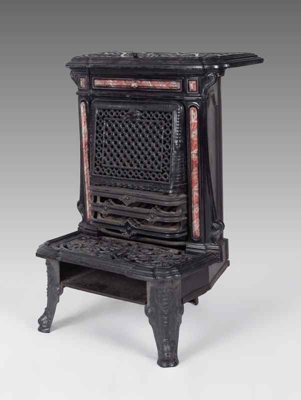 Appraisal: VICTORIAN CAST IRON PARLOR STOVE Filigree cast iron with marble