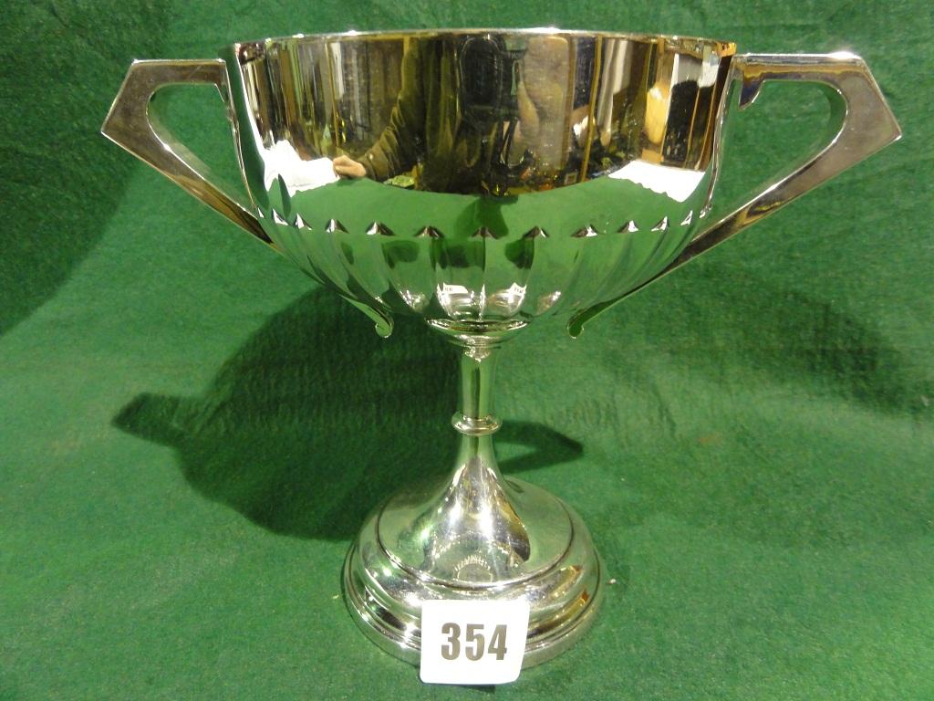 Appraisal: A silver trophy cup made by Walker Hall Sheffield raised