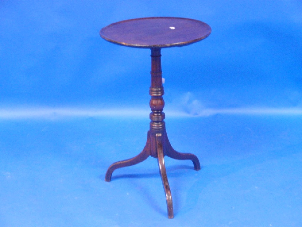 Appraisal: A Georgian mahogany circular tripod table with moulded border on