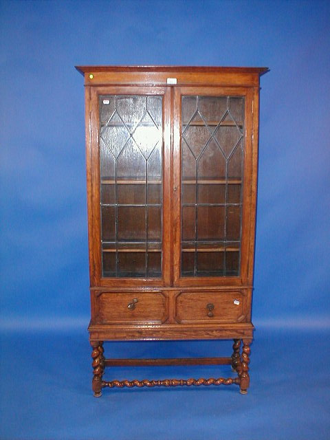 Appraisal: A 's barley twist oak two door display cabinet with