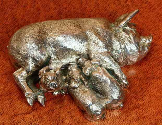 Appraisal: A SILVER MODEL of a sow feeding her piglets signed