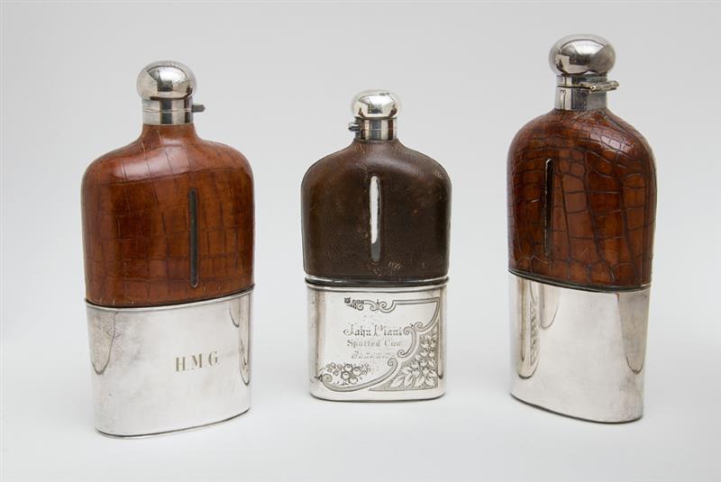 Appraisal: TWO SIMILAR ENGLISH ALLIGATOR SKIN-CLAD AND SILVER-PLATE MOUNTED FLASKS AND