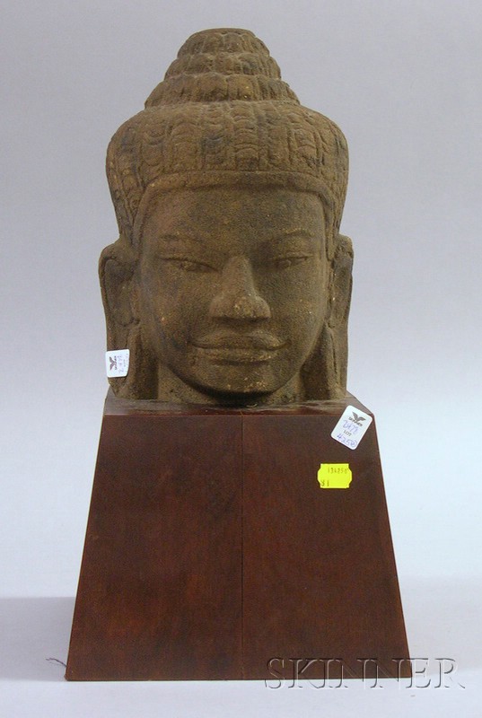 Appraisal: Cambodian Stone Head of a Divinity on Wooden Stand ht