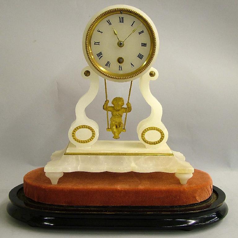 Appraisal: French gilt mounted alabaster cherub on a swing timepiece the