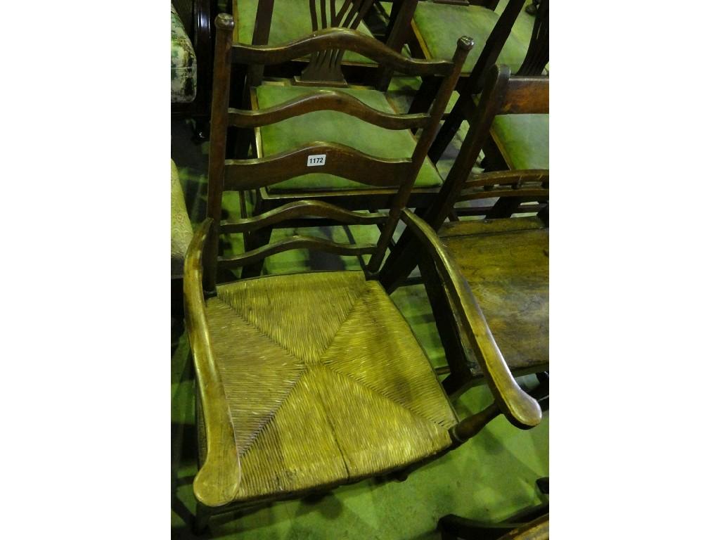 Appraisal: An Edwardian lightweight stained beech wood ladderback open elbow chair