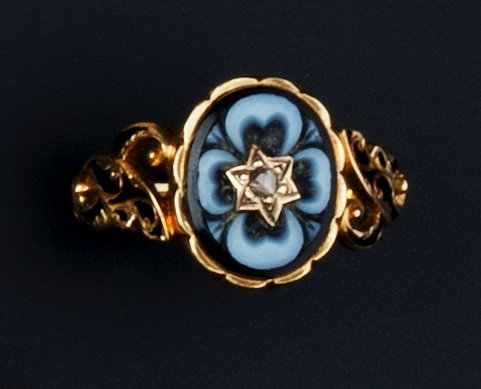 Appraisal: A VICTORIAN ENAMEL ONYX AND DIAMOND MEMORIAL RING the floral