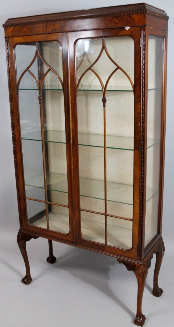 Appraisal: A thC walnut display cabinet the cushioned top with a