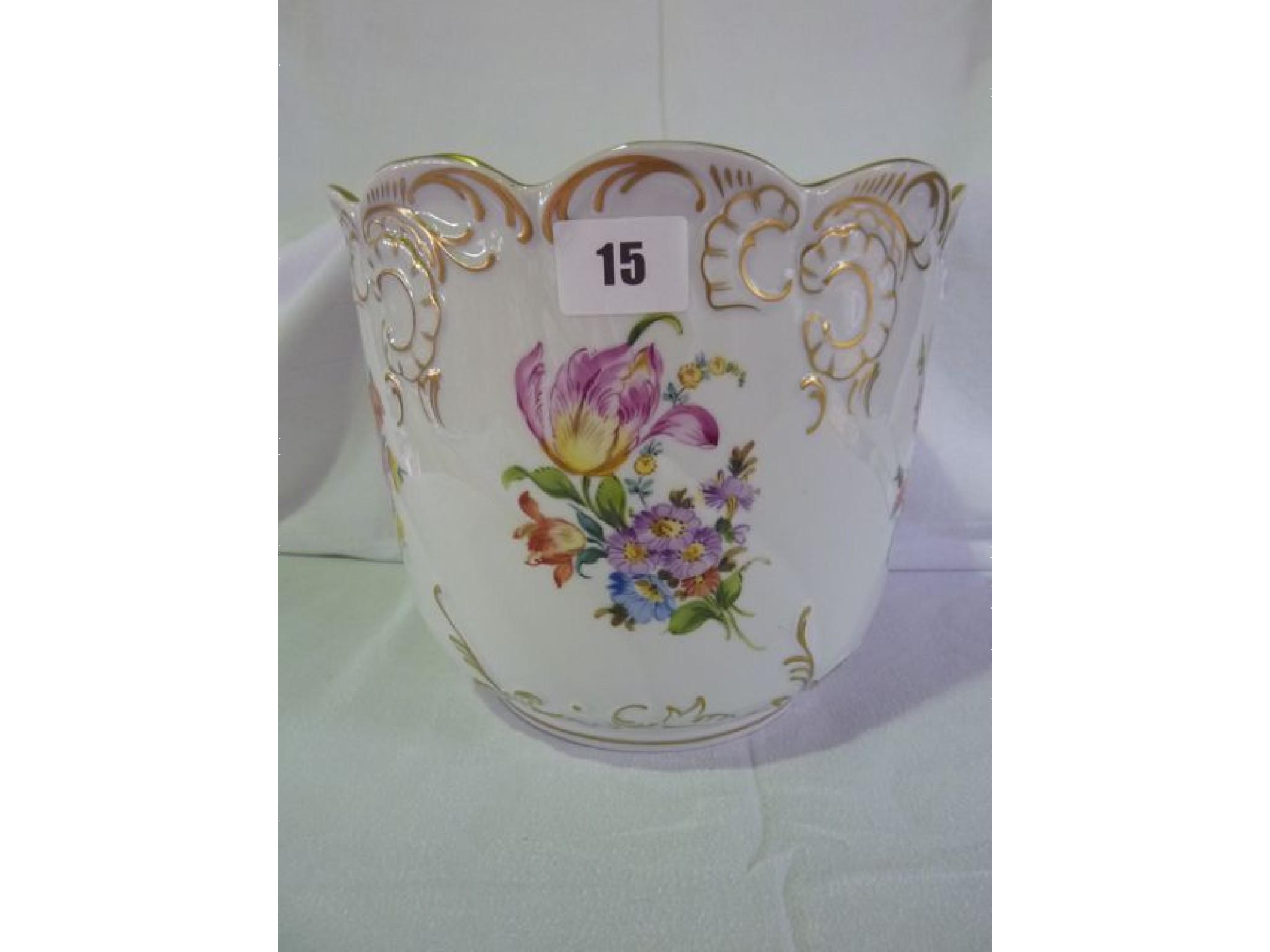 Appraisal: A Dresden jardiniere hand painted with flowers and gilded highlights