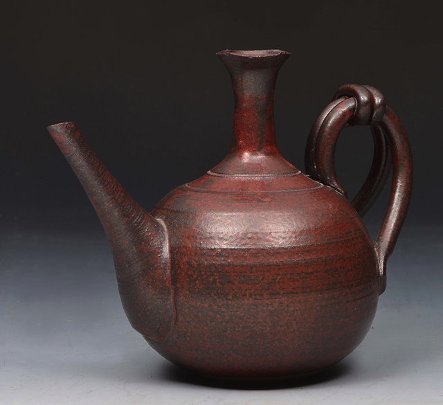 Appraisal: A JAPANESE RAKU POTTERY PITCHER with slender spout ring turned