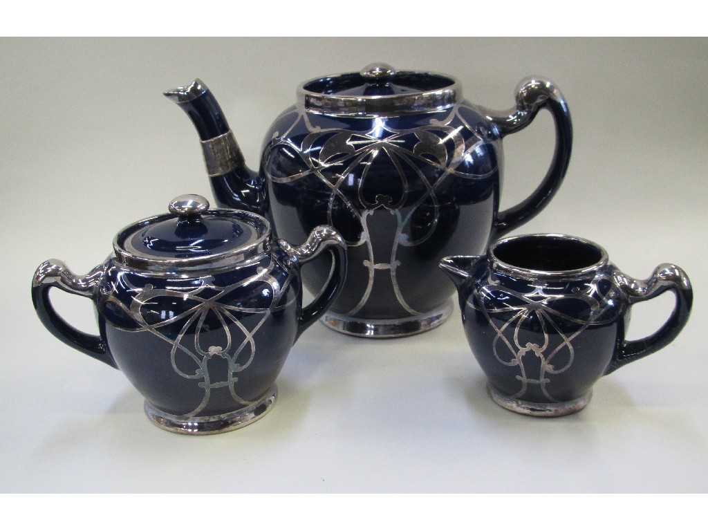 Appraisal: Lennox Ware silver overlaid pottery three piece teaset some def