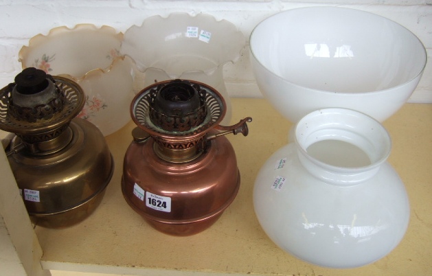 Appraisal: A copper and a brass oil lamp burner and reservoir