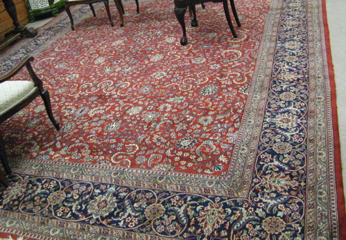 Appraisal: HAND KNOTTED ORIENTAL CARPET Pakistani-Persian overall floral decoration on red