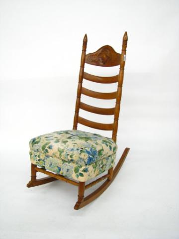 Appraisal: Ladder-back rocking chair with carved portrait back and upholstered seat