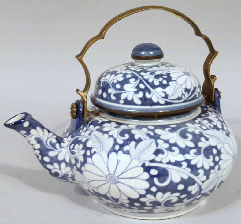 Appraisal: An oriental design ornamental teapot of large proportion with a