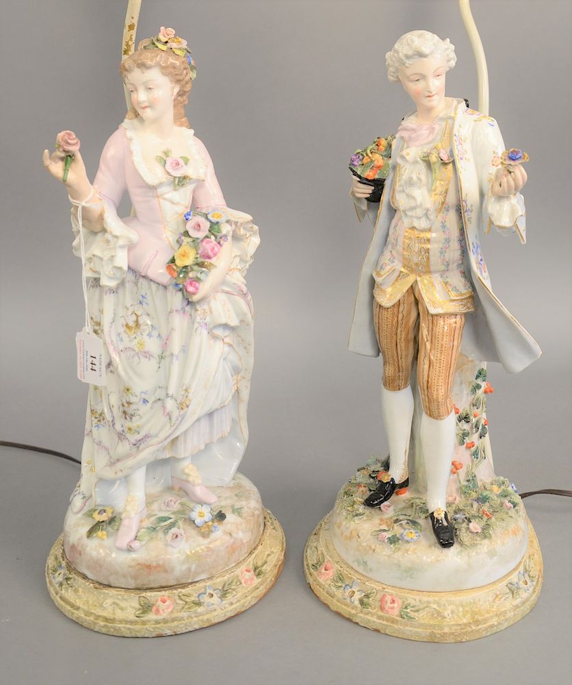 Appraisal: Pair of porcelain figures man and woman each holding a