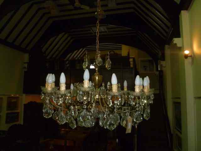 Appraisal: A FIFTEEN BRANCH BRASS HANGING CHANDELIER with profuse hanging lustre