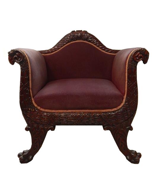 Appraisal: th C armchair with elaborately carved frame plum-colored velvet upholstery