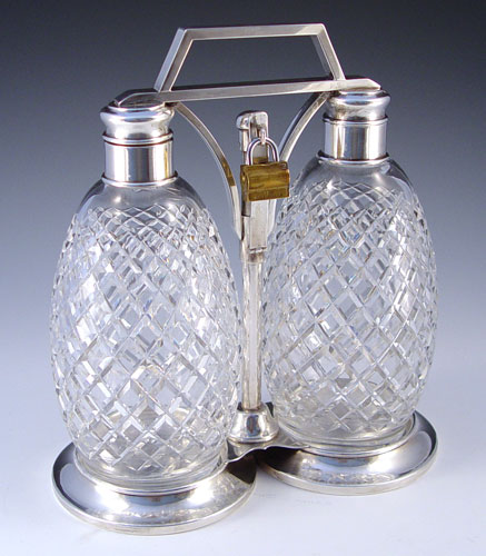 Appraisal: HAWKES STERLING AND CRYSTAL TANTALUS Two crystal bottles cut in