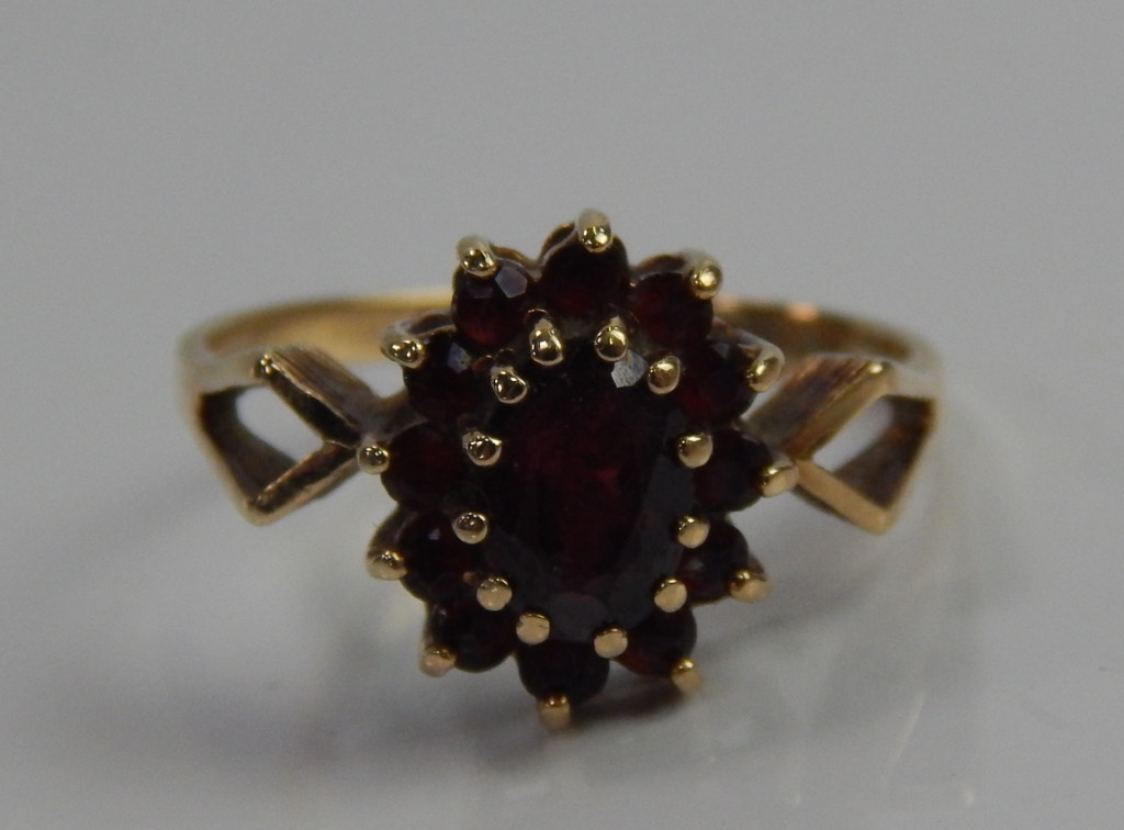 Appraisal: A ct gold dress ring set with garnets in a