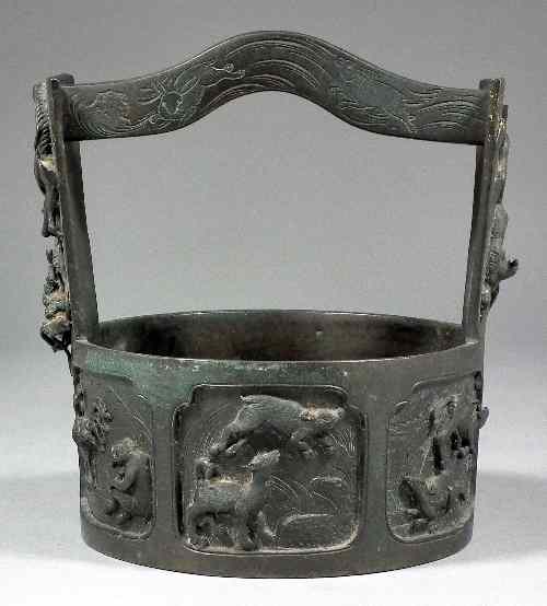 Appraisal: A Chinese bronze bucket cast in relief with animals representing