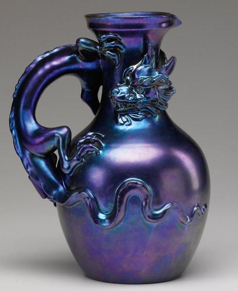 Appraisal: ZSOLNAY Figural pitcher with reticulated dragon under a blue Eosin