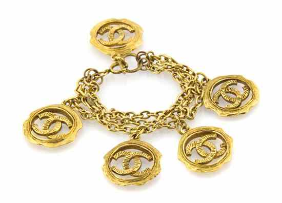 Appraisal: A Chanel Triple Strand Goldtone Charm Bracelet large logo charms