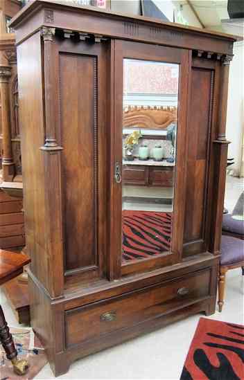 Appraisal: WALNUT SINGLE-DOOR WARDROBE English c a breakfront design with mirror