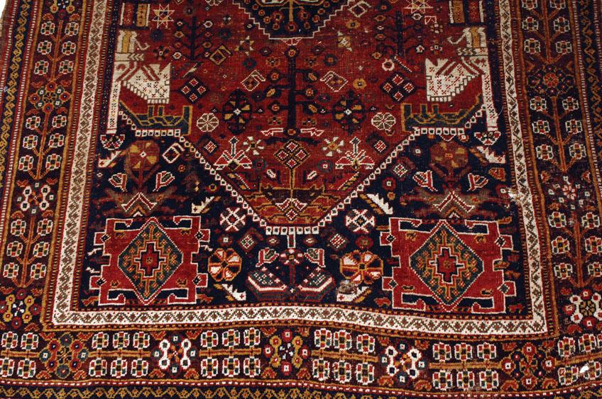 Appraisal: AN AFGHAN TRIBAL RUG the blue ground central panel with