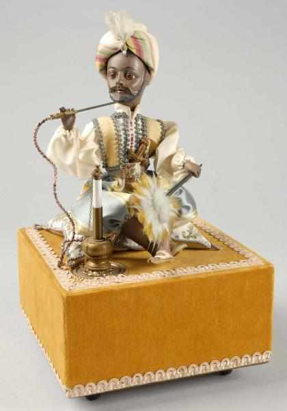 Appraisal: Turkish Man with Turban Automaton with Music Box Description Head