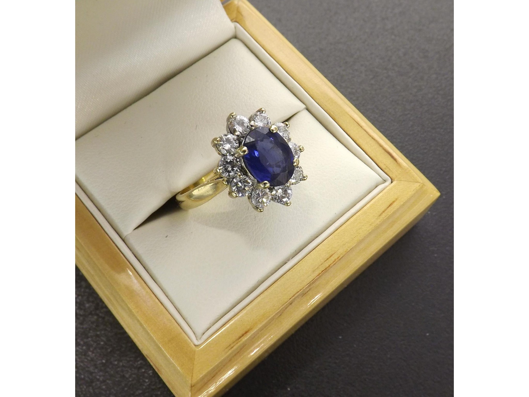 Appraisal: Fine ct oval sapphire and diamond cluster ring the sapphire