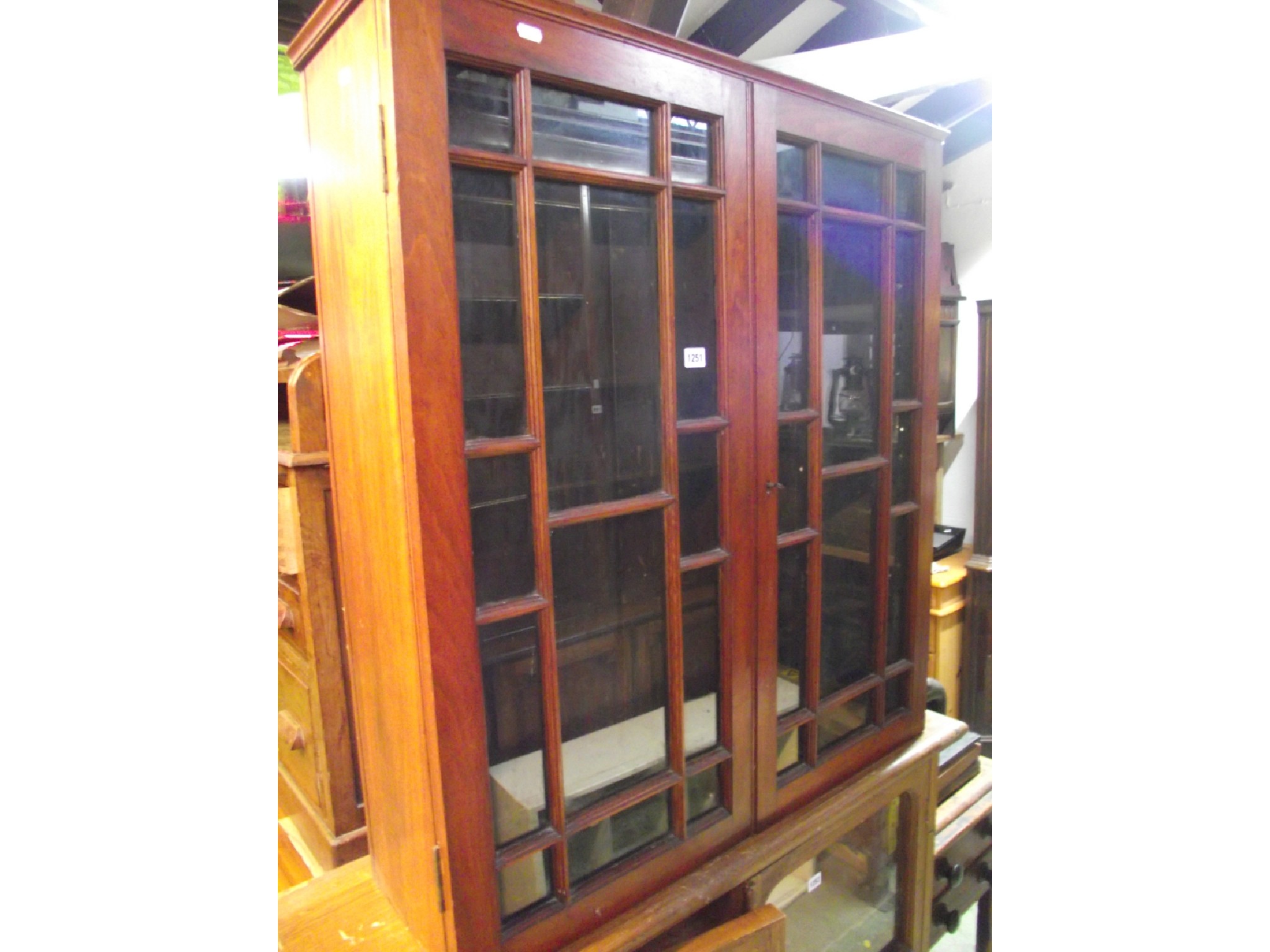 Appraisal: A th century mahogany bookcase enclosed by a pair of