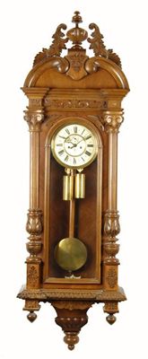 Appraisal: A German walnut regulator wall clock by Gustav Becker with