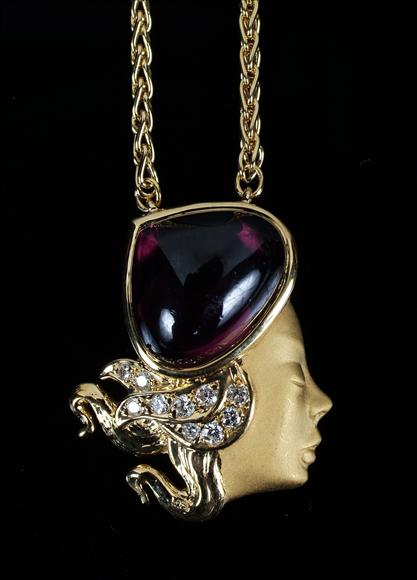 Appraisal: A rhodolite garnet and diamond pendant by Carrera y Carrera