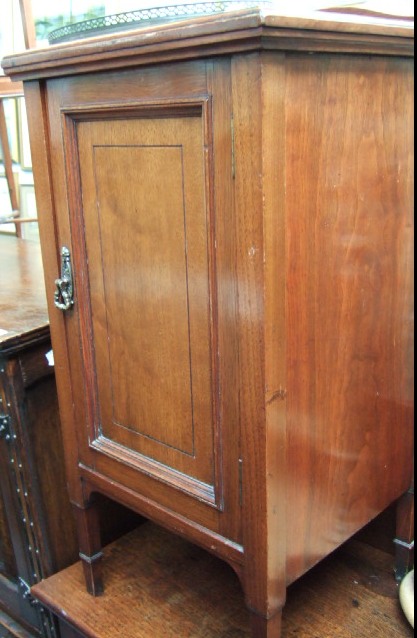 Appraisal: A Victorian walnut pot cupboard with a ledge back and