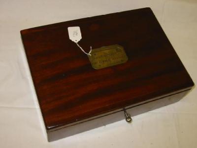 Appraisal: A MAHOGANY BOX of rounded oblong form the hinged lid