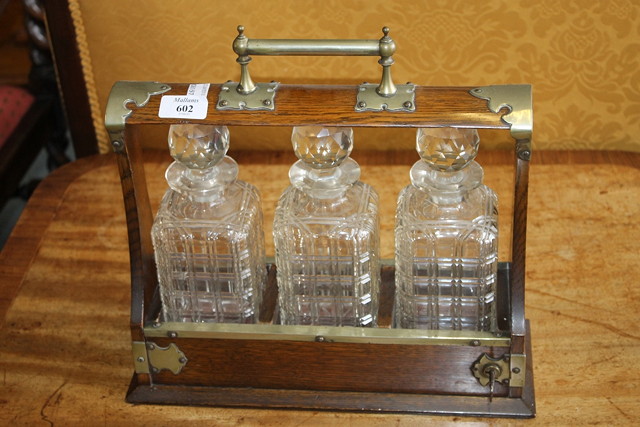 Appraisal: A VICTORIAN OAK TANTALUS fitted three glass decanters cm