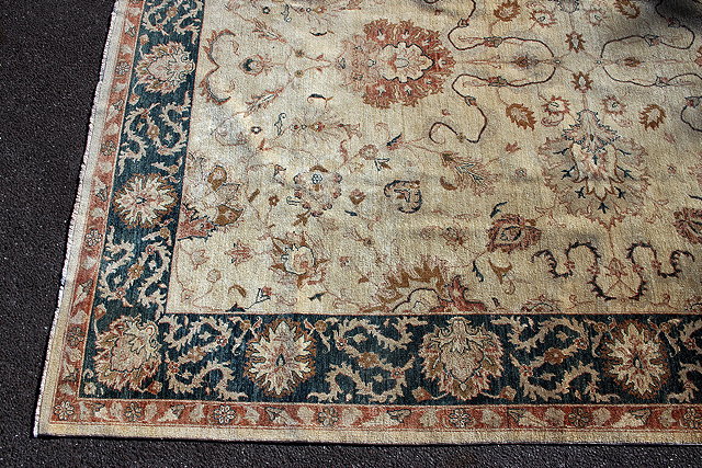 Appraisal: A MODERN CREAM GROUND ORIENTAL RUG with floral decoration to