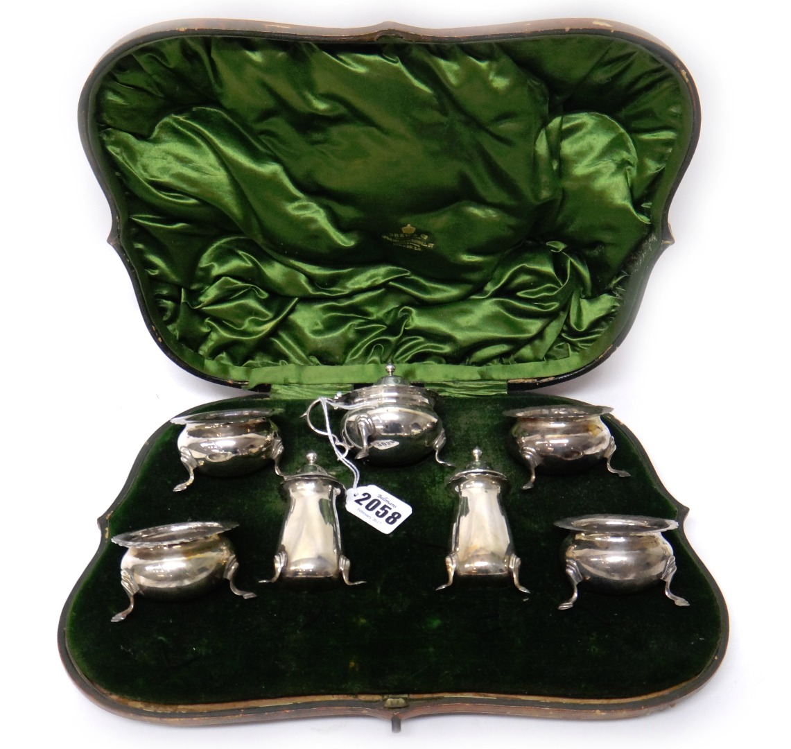 Appraisal: A silver seven piece condiment set comprising four salts lacking