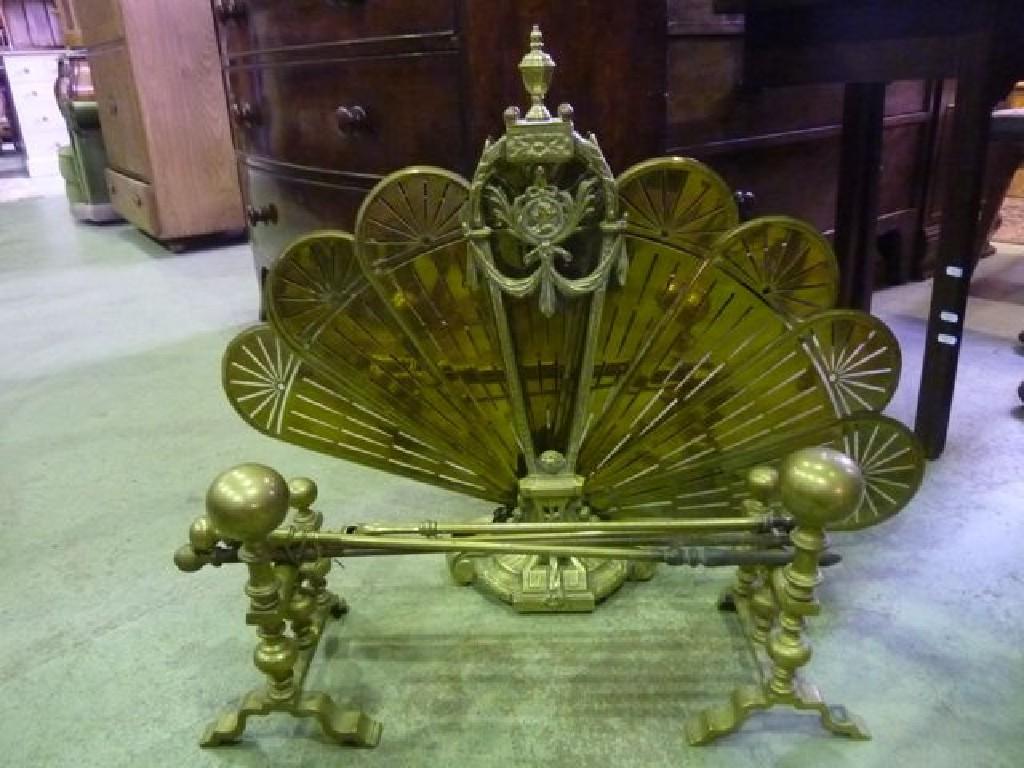 Appraisal: A cast brass firescreen with internal folding pierced fan panels