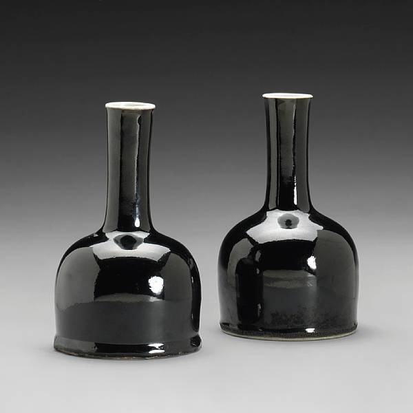 Appraisal: A pair of 'mirror black' glazed porcelain mallet-form vases Kangxi